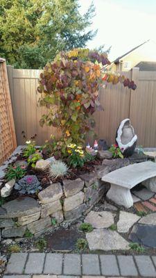 A cozy sitting area. A good way to use space in a small yard.