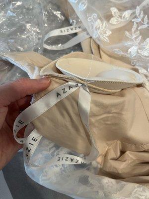 They accidentally SEWED ON the hanger strap onto a boob pad.  Why didn't they just restart and redo?! I can't properly hang my dress up now.