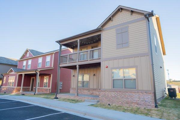 All cottages have a front entrance and back entrance that leads to a small patio area. Some cottages have balconies on the second floor.