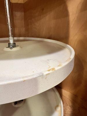 Food dripping on inside of cleaned kitchen cabinet.