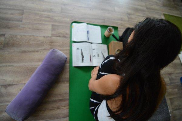 Interconnected Yoga Teacher Trainee studying handstand.