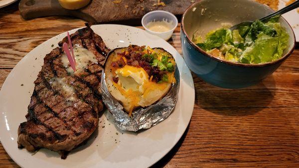 New York Strip (Medium Rare), loaded baked potato, and a side ceaser.