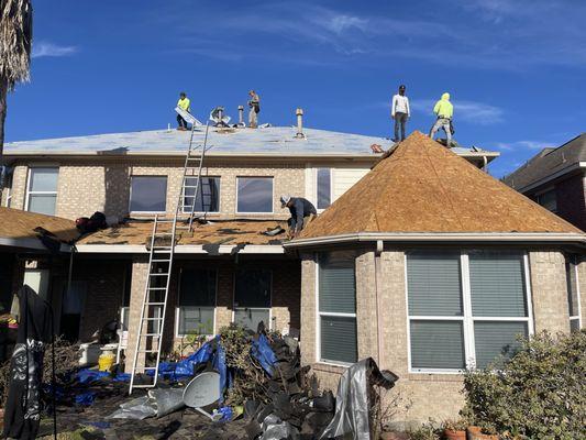 Old shingles being removed on lower section.