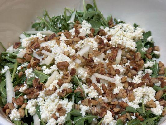 Arugula, Gorgonzola, Pears, and candied pecans with a honey lemon vinaigrette.