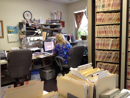 View of main office and staff member on phone with patient