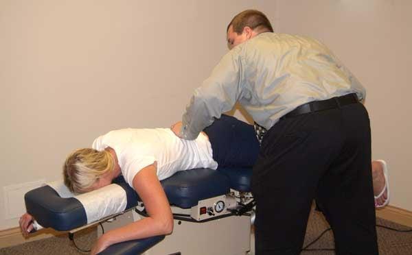 Our bright and energetic Dr. Porterfield checking a patients lower back