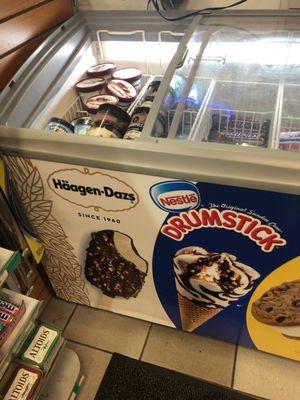 ICE CREAM PINTS OF DIFFERENT BRANDS FOR SALE in freezer near register counter