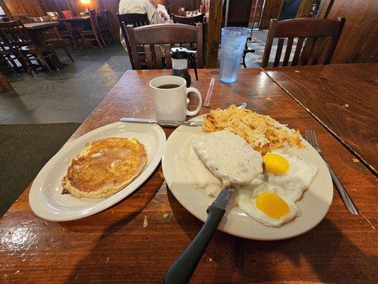 Country fried steak, eggs sunnyside up, and pancake