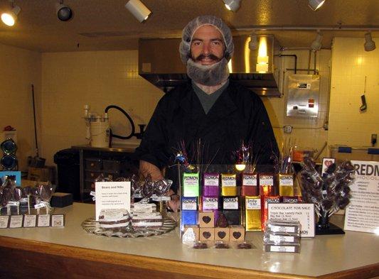 Owner and operator, Patrick, stands behind his display of single origin chocolate bars.