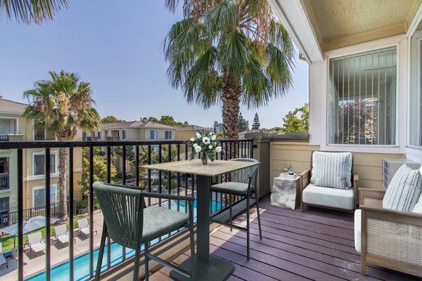 Private balcony with chairs and a table.