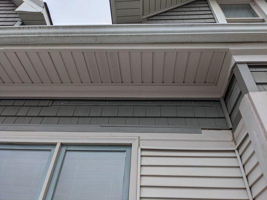 Siding falling off the house; example of the improperly installed lower trim piece.