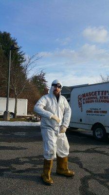 Mike suiting up to go down into a septic tank.  Where's your goggles, son?