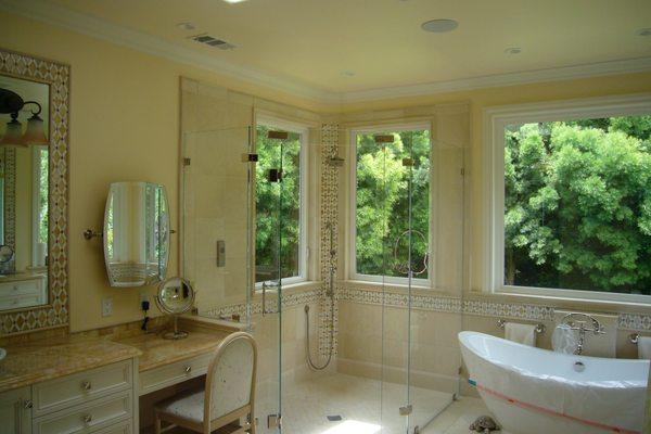 master bathroom with sunken shower, no curb, custom glass and onyx counter tops with lighting underneath