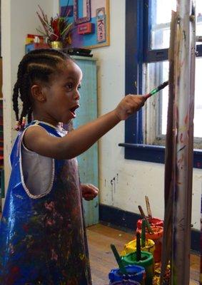 Open studio customer fully engaged in her painting.