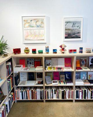 Our poetry section--the art on the wall is by Kathleen McShane and sculptures below are by Ben Peterson.