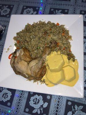 Peruvian Arroz con pollo with potatoes topped with huancaina sauce