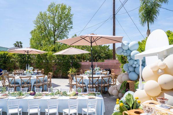 Round tables, wooden chairs, umbrella, kids tables, kids chairs, candy cart and table cloths all provided by Orchid Party Rental.