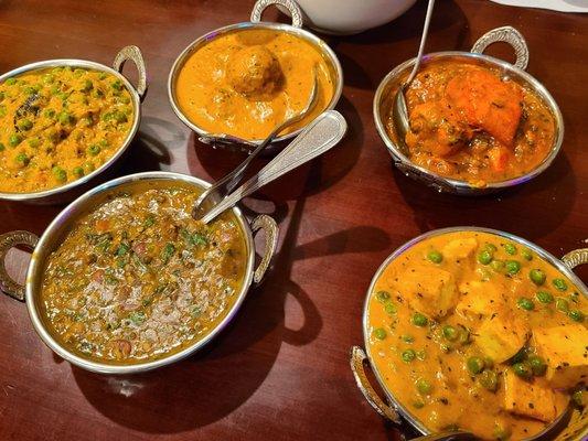 Left to right, Baingan Bharta eggplant curry, Dal Makhani, Malai Kofta, Namaste Fish Curry with Salmon, and Mattar Paneer curry.