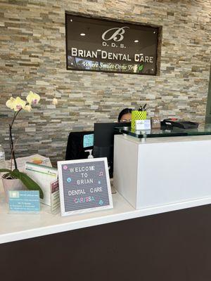 Brian Dental front desk with custom sign for new patient