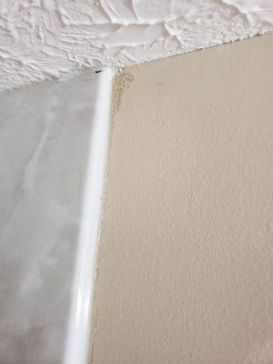 The light cream rolled right off the caulk....the dark cream shows underneath because of the non-paintable caulk used