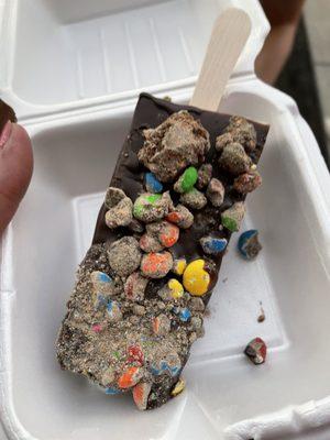 cookies and creme paleta covered in dark chocolate with m&ms.. Holy moly was this a tasty treat