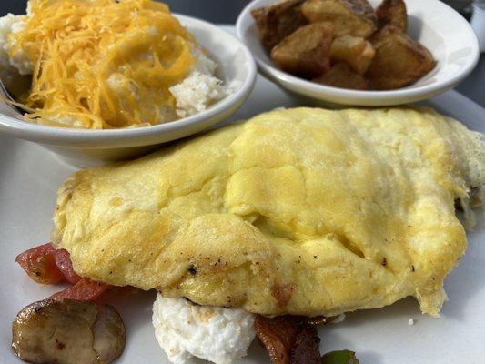 Customized omelette with a side of potatoes and cheddar grits