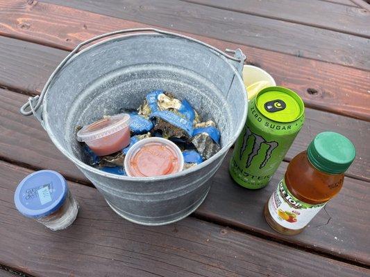 Bucket of oysters and delish cocktail sauce, oyster shooter in a souvenir shot glass.