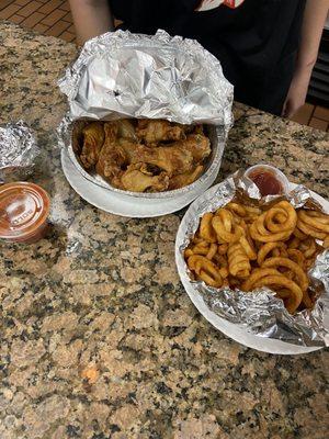 Here are the delicious curly fries and the dozen wings with hot buffalo sauce on side!