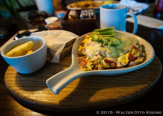 The Famous Mexican Skillet: Scrambled Eggs with Ham and Swiss Cheese and Avocado on top of a bed of Black Beans, Tomatoes and Fried Spuds.