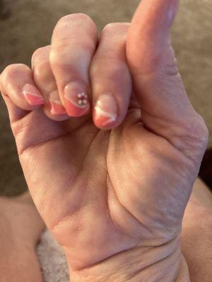 Short, uneven nails with a flower.