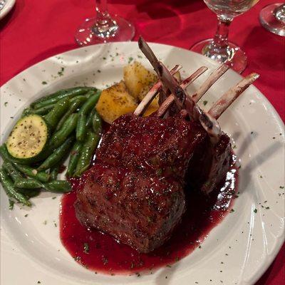 Rack of lamb with raspberry sauce.