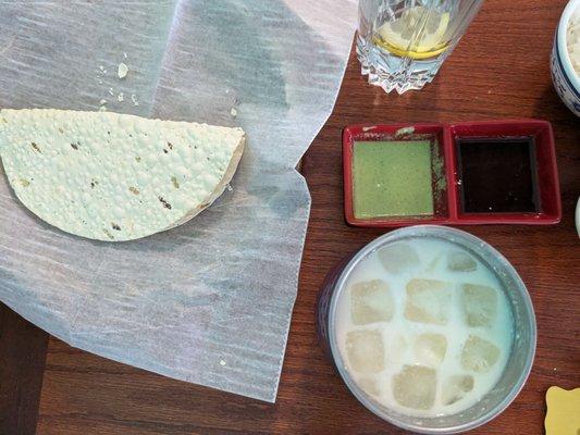 Papad with chutneys, and a sweet lassi (buttermilk drink)