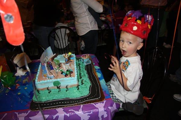 tyler's 3rd birthday cake- toy story theme, eating the black frosting!