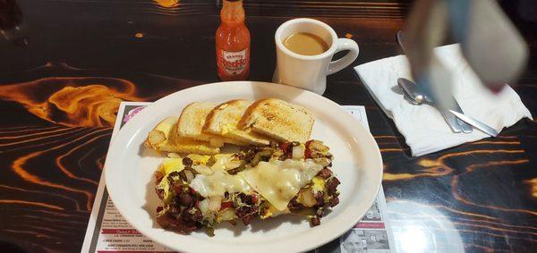 Meatlovers omelette with peppers, onions and pepper jack cheese and sourdough bread.