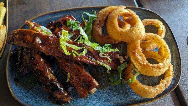 Slow cooked and grilled BBq pork ribs that fall off the bone and fresh and crispy onion rings cooked to perfection.