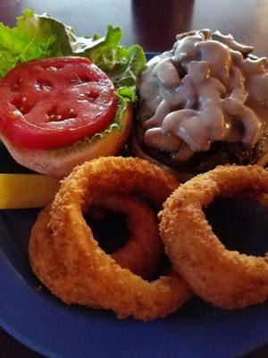 Mushroom and swiss burger with onion rings on the side