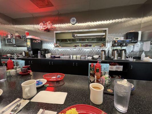 Sitting at the counter having a great meal.