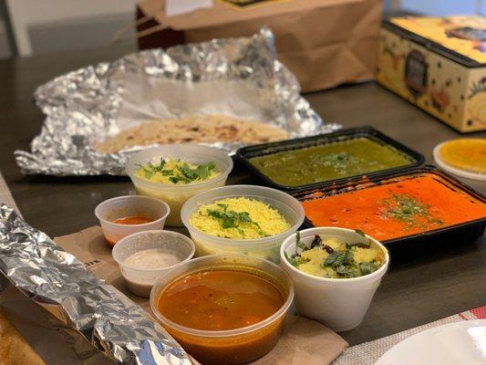 Butter chicken, saag paneer, Naan, dosa, and rice