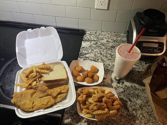 Tilapia dinner with fries, shrimp snack, corn fritters and pink lemonade.