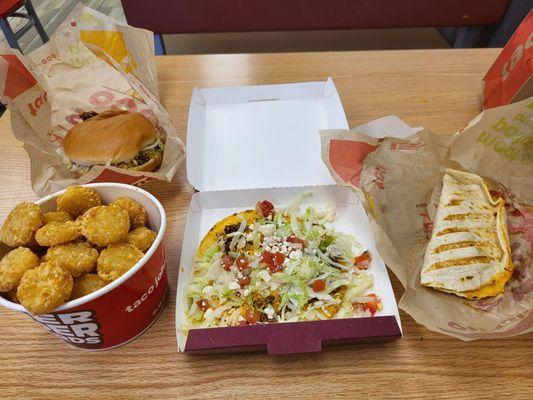 Quite the spread - Taco Beef Burger, Potato Oles,  Beefy Tostada, Chicken Quesadilla.