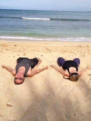 Stretching with the owner after after inversions after yoga at the beach