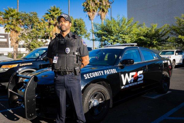 Wolfpack Protective Services guard with one of our patrol vehicles.