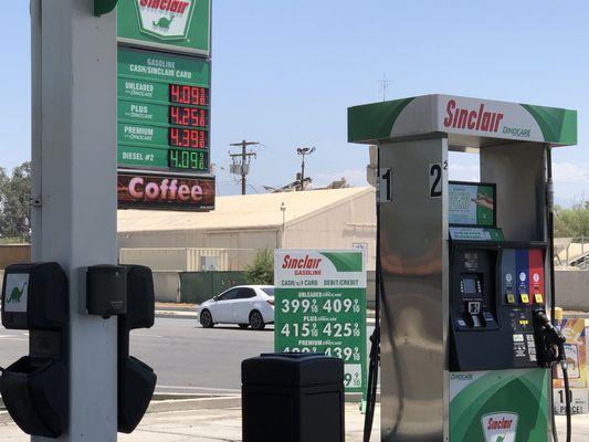 Signage and gas pumps.