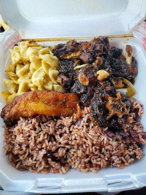 Oxtails with rice and peas with mac and cheese and plantains