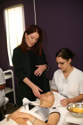 Instructor assisting a student with a treatment analysis.