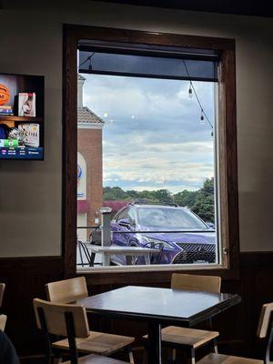 A window looking out to the outside seating area.