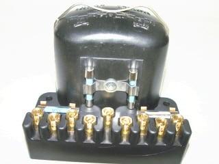 New reproduction of the original nine post voltage regulator that includes the fuse holder with new fuses.