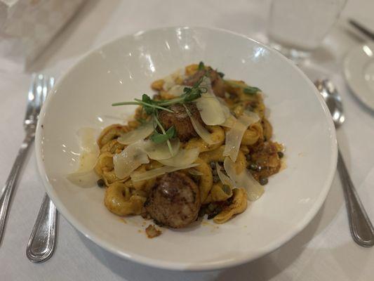 Three cheese tortellini with sun-dried tomatoes and vodka sauce with fresh Parmesan and seared scallops