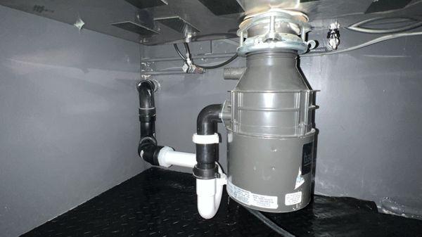 Installation of p-trap assembly and garbage disposal.