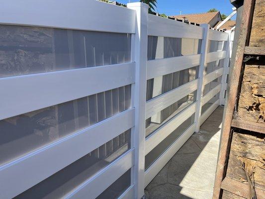 New modern stile vinyl fence with light gray color glass